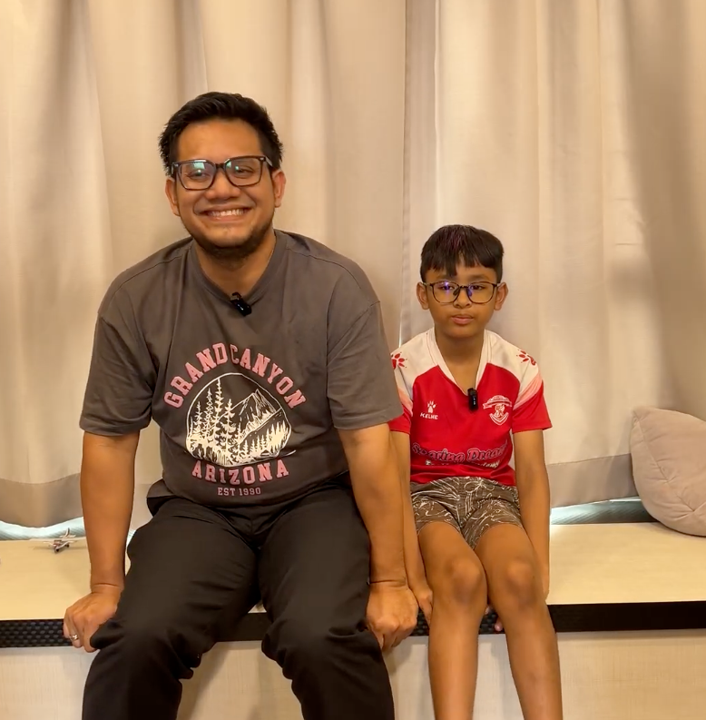 Adam sitting with his dad, Taufiq